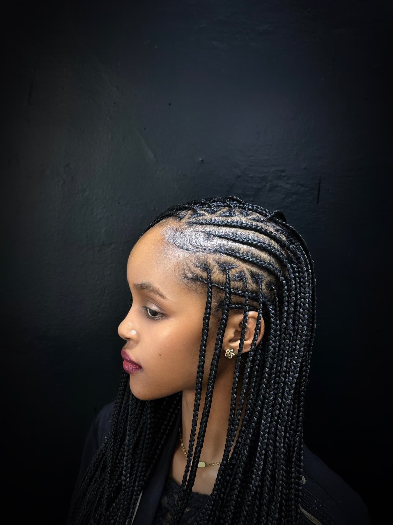 Side profile of fine braided cornrows